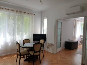 a dining room with a table and chairs at Апартамент BOHO CHIC 2 Free parking in Varna City