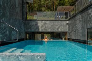a man in a swimming pool in a house at Landhotel Sternwirt - Das Wellnesshotel zwischen Nürnberg und Amberg in Högen