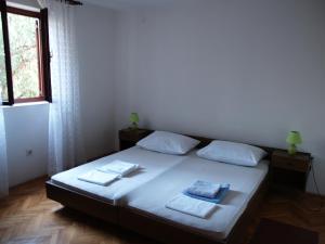 - une chambre avec un lit et 2 serviettes dans l'établissement Apartments by the sea Brna - Vinacac, Korcula - 13344, à Prižba
