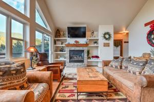 a living room with couches and a fireplace at Mountain Vistas - Lake Views at Buffalo Sunrise in Green Mountain Falls