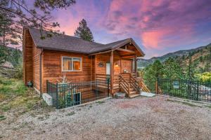 a cabin in the mountains with a sunset at Mountain Vistas - Lake Views at Buffalo Sunrise in Green Mountain Falls