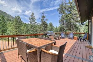 a deck with a table and chairs and a grill at Cozy Mountain Cabin in Cascade in Cascade-Chipita Park