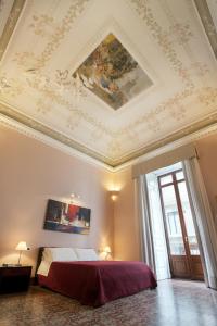 a bedroom with a bed and a painting on the ceiling at Antiche Volte in Catania