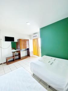 Säng eller sängar i ett rum på INTER HOTEL JACARAÍPE