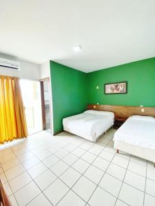 Posteľ alebo postele v izbe v ubytovaní INTER HOTEL JACARAÍPE