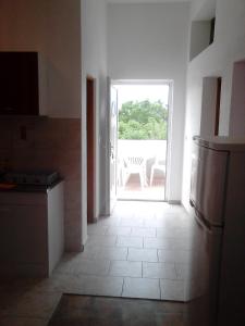 a kitchen with a door leading to a patio at Apartment Nin 13158b in Nin +6 photos