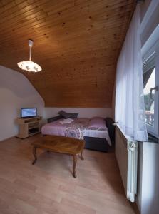 a bedroom with a bed and a wooden ceiling at Apartments with a parking space Smoljanac, Plitvice - 14979 in Smoljanac