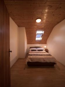 a bedroom with a bed with a wooden ceiling at Apartments with a parking space Smoljanac, Plitvice - 14979 in Smoljanac