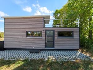 a tiny house sitting on top of a gravel lot at Haus Jagstblick in Kirchberg an der Jagst