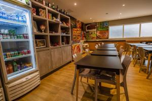 a dining room with a table and a refrigerator at Transamerica Fit Campo Grande in Campo Grande