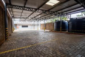 a large warehouse with two tanks and a brick floor at Transamerica Fit Campo Grande in Campo Grande