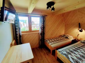 a room with two beds and a window at Willa pod Limbami in Zakopane