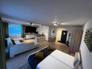 a room with two beds and a living room with a couch at Bruno Apartments in Cluj-Napoca +32 photos