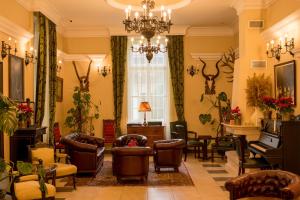 a living room with chairs and a piano at Kaštel Ečka in Ečka