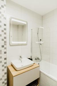 a white bathroom with a sink and a shower at Skylark - Singapore Penthouse with Jacuzzi & Panoramic View in Braşov +30 photos