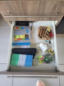 a drawer filled with books and other office supplies at Ollies in Pretoria