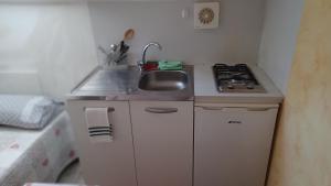 a small kitchen with a sink and a stove at il monolocale in Turin