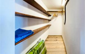 a walk in closet with blue and green towels at Nice Home In Stegersbach With 1 Bedrooms in Stegersbach