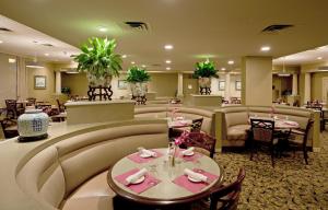 a hotel lobby with tables and chairs and a restaurant at Holiday Inn Portland-By the Bay, an IHG Hotel in Portland