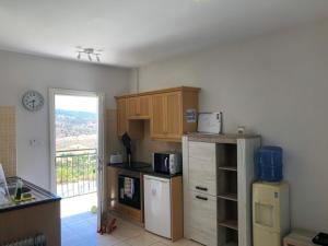 a kitchen with a refrigerator and a counter top at Panoramic Holidays - Standard 50 in Peyia