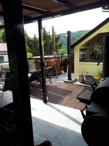 an open patio with a deck with chairs on it at Apartment u Frejštejna in Podhradí nad Dyjí