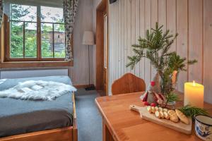 a bedroom with a bed and a table with a candle at Pokoje Samo Centrum in Zakopane