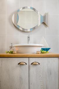 a bathroom with a sink and a mirror on the wall at Whale & Tortoise - Lampiesbaai in St Helena Bay