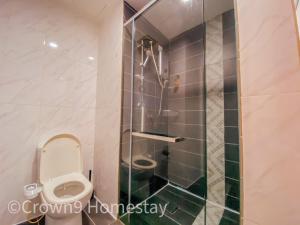 a bathroom with a toilet and a glass shower at Crown9 Suite (Sunset & City View)@Empire City in Petaling Jaya