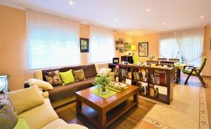 a living room with a couch and a table at GALIHOST - Finca de Roque in O Grove