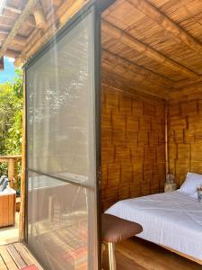 a room with a bed and a sliding glass door at Hakuna Matata glamping Salento timón in Salento