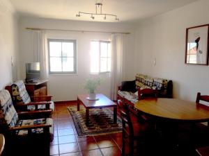 a living room with a table and chairs at Sesimbra Concept in Sesimbra