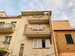 a tall building with two windows and two balconies at L'appartamento di Rita in Nettuno