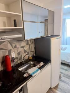 eine Küche mit einer Spüle und einem Kühlschrank in der Unterkunft FLAT Beverly Hills 401B in Vila Velha