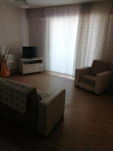 ein Wohnzimmer mit einem Sofa und einem TV in der Unterkunft Rainfort turizm sanayi ve ticaret ltd şti in Denizli