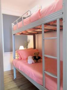 a teddy bear sitting on top of a bunk bed at Hanns&KingBed&WIFI&Pool& Parking&Sauna&Sunshine Classic Comfort Homstay in Sibu
