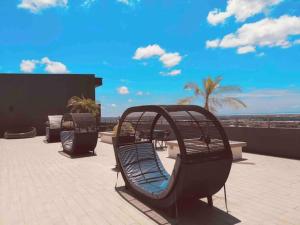 a bench sitting on a patio overlooking the ocean at Hanns&KingBed&WIFI&Pool& Parking&Sauna&Sunshine Classic Comfort Homstay in Sibu