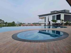a large swimming pool in front of a house at Hanns&KingBed&WIFI&Pool& Parking&Sauna&Sunshine Classic Comfort Homstay in Sibu