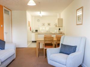 a kitchen and dining room with two chairs and a table at Flat 33 - Marine Court in Littlehampton