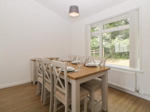 a dining room with a table and chairs and a window at Harcombe House&nbspPet Free Bungalow in Newton Abbot