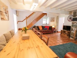 a living room with a wooden table and a couch at Preswylfa in Conwy