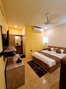 a bedroom with a bed and a television in it at Hotel Aurelia Pearl in Patna