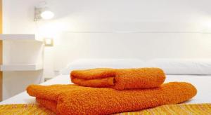 three towels stacked on top of a bed at APARTMENT ORANGE FUERTEVENTURA in Puerto del Rosario