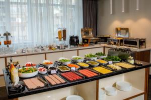 a buffet with different types of food on a table at Median Hotel, City Center Yerevan in Yerevan