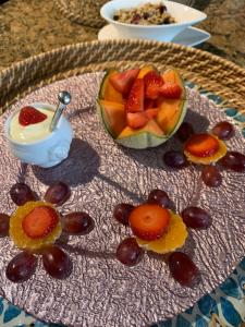 um prato coberto com fruta e uma taça de iogurte em Bybrook Barn Bed & Breakfast em Loughborough