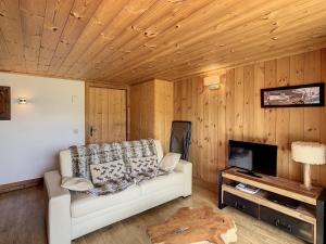 a living room with a couch and a fireplace at Appartement Combloux, 3 pièces, 5 personnes - FR-1-560-27 in Combloux