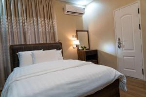 Postel nebo postele na pokoji v ubytování Integral Consults Apartment