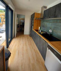 a kitchen with wooden floors and a counter top at La Belle Vie en Alaric in Douzens