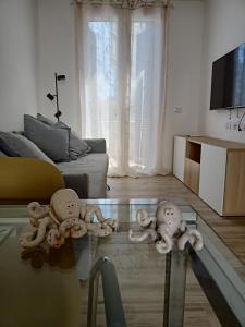 three dolls on a glass table in a living room at Il PolpoLeo in Porto Azzurro Isola d'Elba in Porto Azzurro