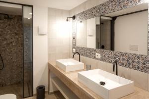 a bathroom with two sinks and a mirror at Masseria Specchiulla in Otranto +146 photos