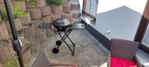 a grill on a tripod in front of a building at Kleine Auszeit in Mendig